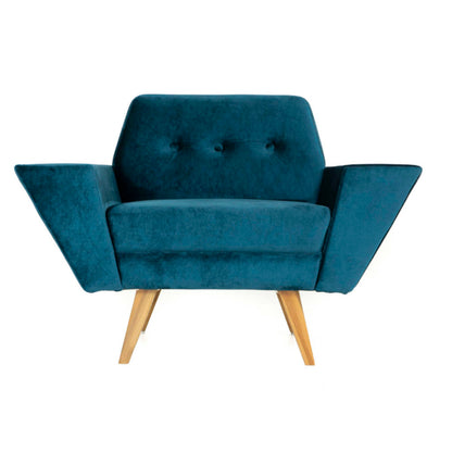 The Wide Armset Sofa from Tooba Furniture Factory is a modern, dark blue velvet armchair with wooden legs. It features a unique design with one extended armrest, a button-tufted backrest, and angled lines that give it a contemporary and stylish appearance. The chair is displayed against a plain white background.