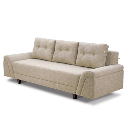 A light beige Meta Boucle sofa from Tooba Furniture Factory, featuring three back cushions, is displayed against a white background. This three-seater sofa boasts a modern design with plush upholstery and slightly angled armrests. It rests on four short, dark wooden legs.