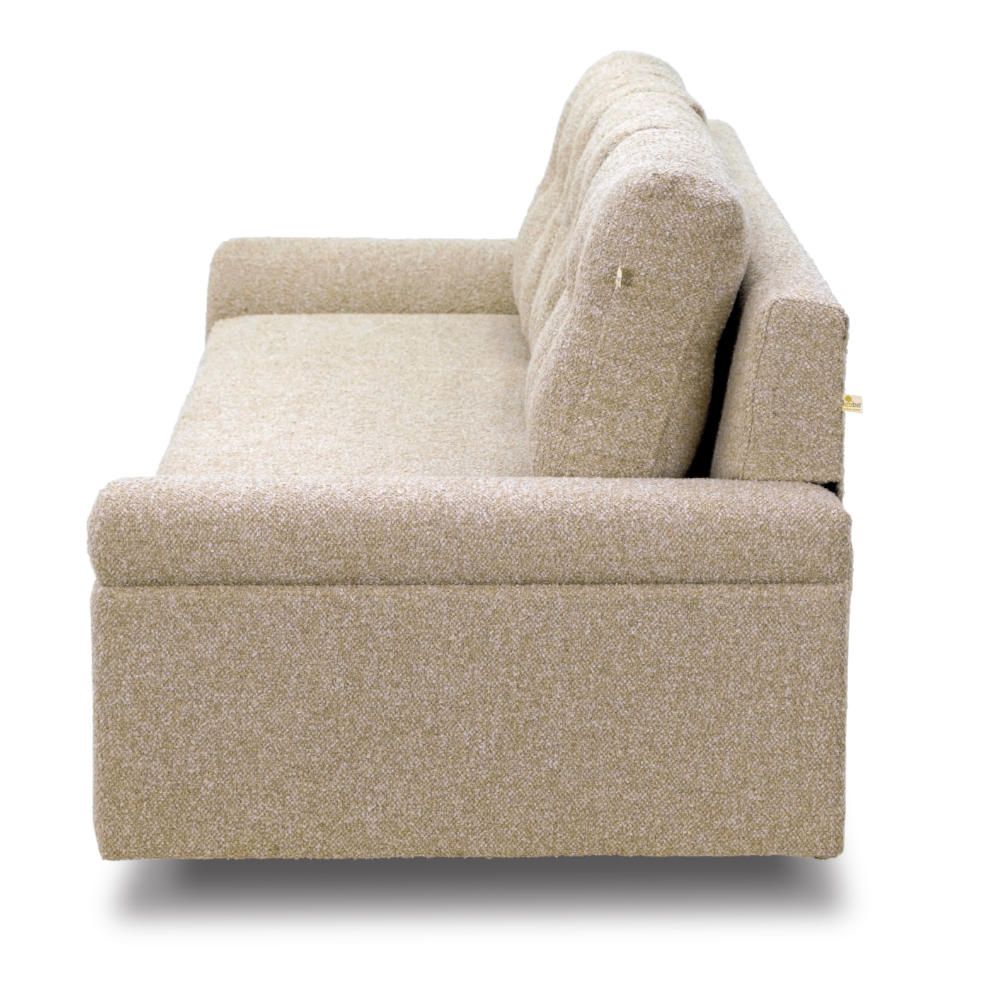 A light beige Meta Boucle sofa from Tooba Furniture Factory, featuring three back cushions, is displayed against a white background. This three-seater sofa boasts a modern design with plush upholstery and slightly angled armrests. It rests on four short, dark wooden legs.