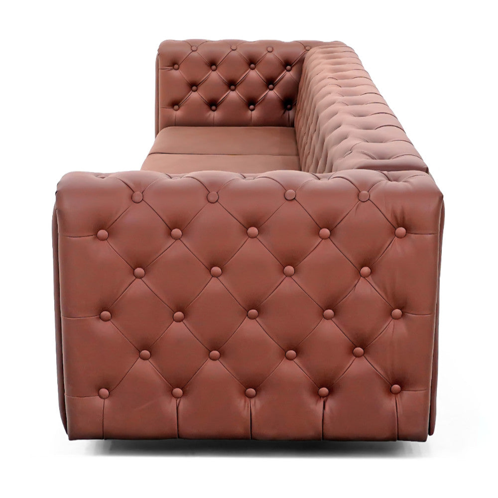 The Modern Chesterfield Sofa by Tooba Furniture Factory is a brown, tufted leather L-shaped couch with a large chaise lounge on the left side. This corner sofa features clean lines and sits on short black and gold legs, with upholstery detailed in a classic button-tufted pattern.