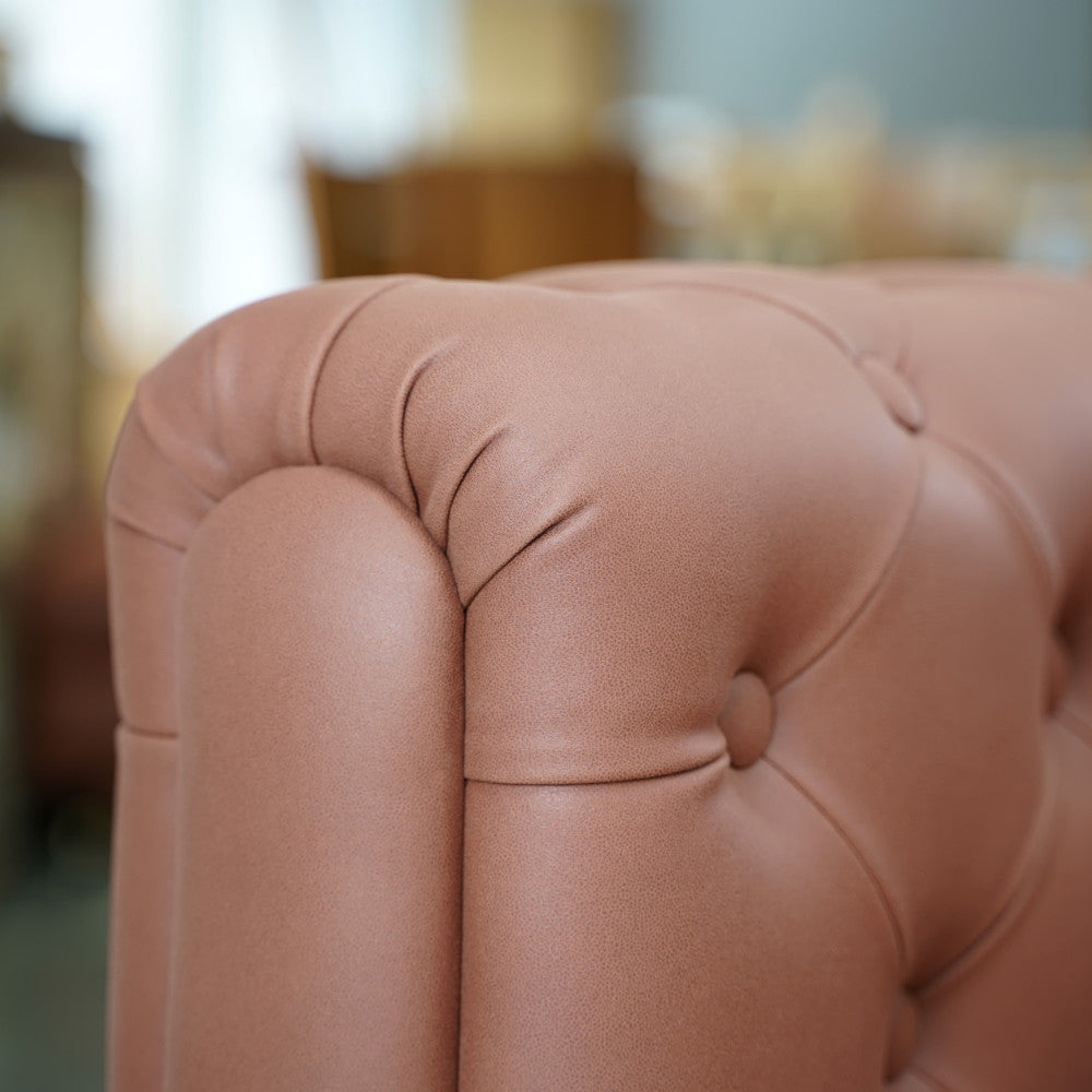 The Modern Chesterfield Sofa by Tooba Furniture Factory is a brown, tufted leather L-shaped couch with a large chaise lounge on the left side. This corner sofa features clean lines and sits on short black and gold legs, with upholstery detailed in a classic button-tufted pattern.