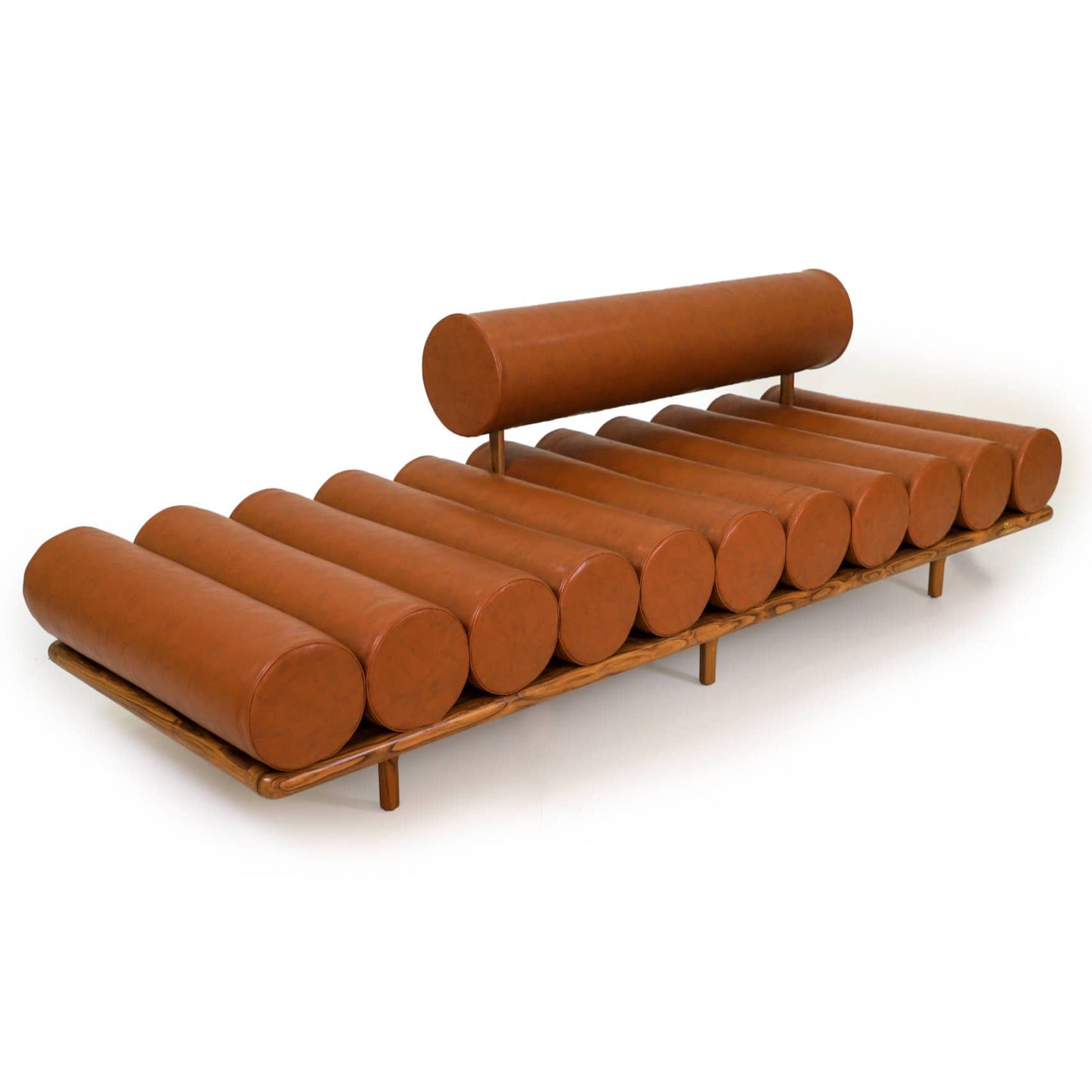 The Cylinder Cushion Sofa by Tooba Furniture Factory is a modern, minimalist piece with a distinct design featuring multiple cylindrical cushions arranged horizontally on a wooden frame. The cushions are upholstered in brown leather, and the backrest is made from a single, long cylindrical cushion.