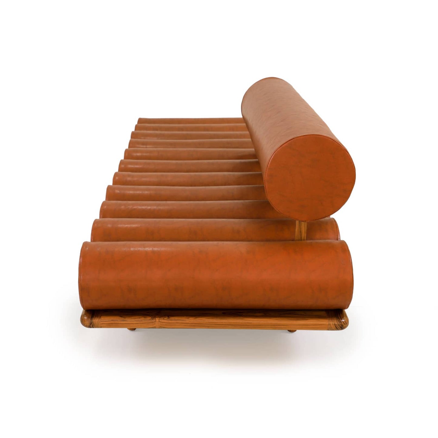 The Cylinder Cushion Sofa by Tooba Furniture Factory is a modern, minimalist piece with a distinct design featuring multiple cylindrical cushions arranged horizontally on a wooden frame. The cushions are upholstered in brown leather, and the backrest is made from a single, long cylindrical cushion.