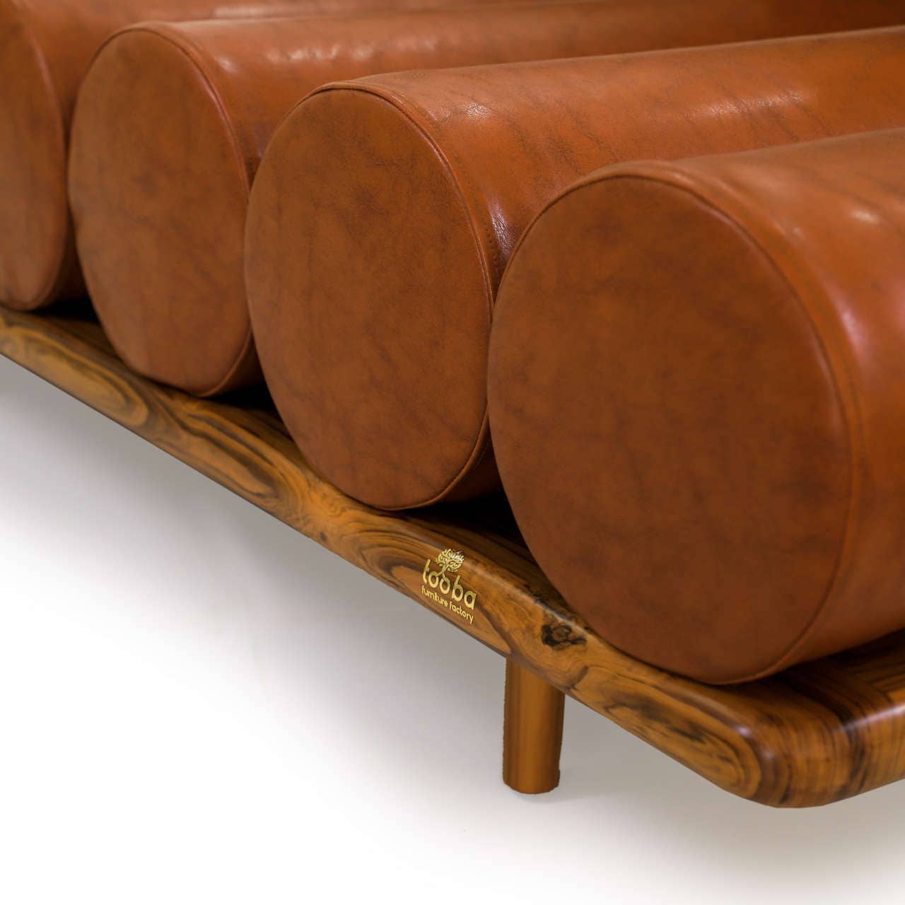 The Cylinder Cushion Sofa by Tooba Furniture Factory is a modern, minimalist piece with a distinct design featuring multiple cylindrical cushions arranged horizontally on a wooden frame. The cushions are upholstered in brown leather, and the backrest is made from a single, long cylindrical cushion.