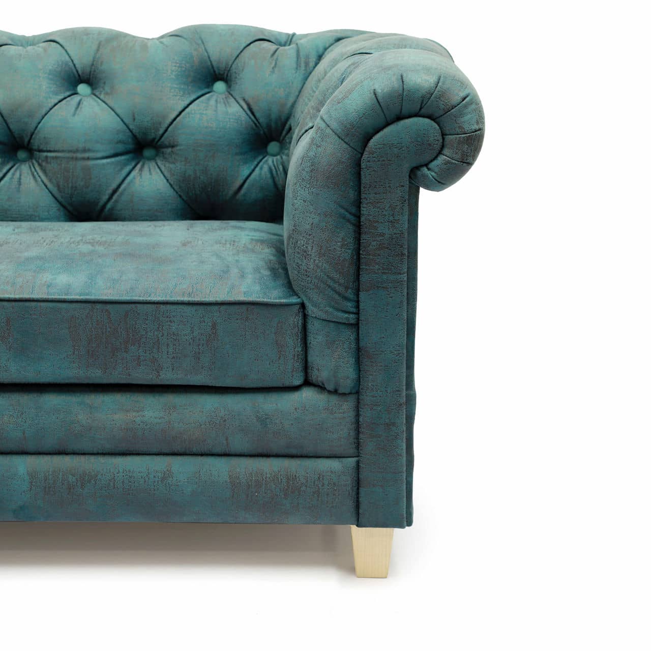 A teal, tufted velvet Chesterfield Sofa by Tooba Furniture Factory with rolled arms and back, featuring two seat cushions and standing on short wooden legs. The fabric appears plush and luxurious, with deep button detailing on the back and arms—truly a statement sofa exuding medieval elegance.