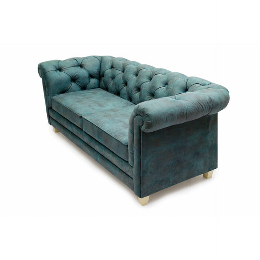 A teal, tufted velvet Chesterfield Sofa by Tooba Furniture Factory with rolled arms and back, featuring two seat cushions and standing on short wooden legs. The fabric appears plush and luxurious, with deep button detailing on the back and arms—truly a statement sofa exuding medieval elegance.