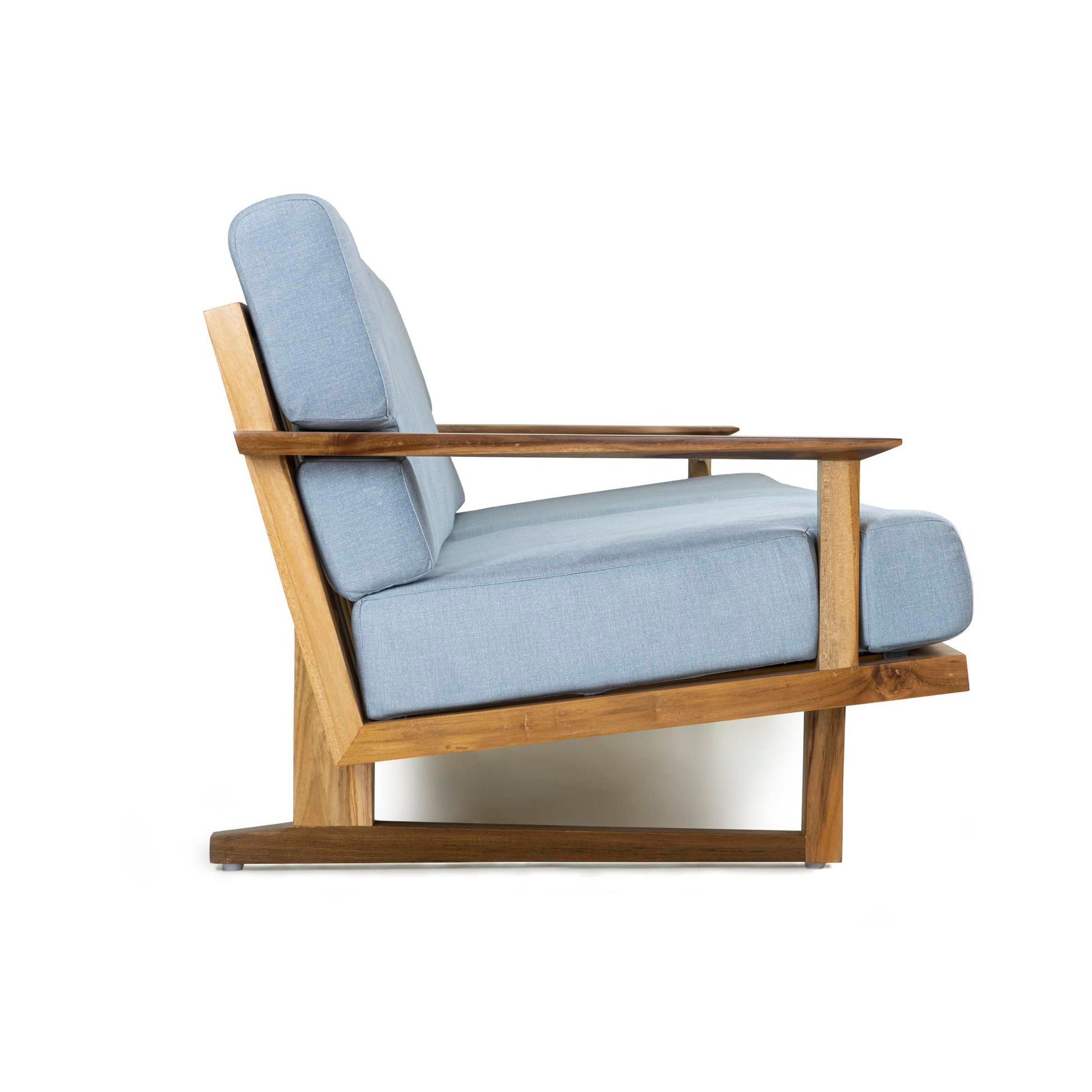 The Spoke Wooden Sofa by Tooba Furniture Factory is a modern mid-century style wooden piece with a minimalist design. It features light-blue fabric cushions and angled armrests, complemented by a sleek wooden frame with a natural finish. This exquisite sofa comfortably seats three and has a slightly reclined backrest for added comfort.